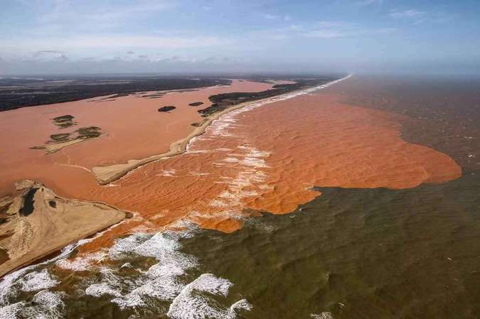 Wave of mud reaches the coast