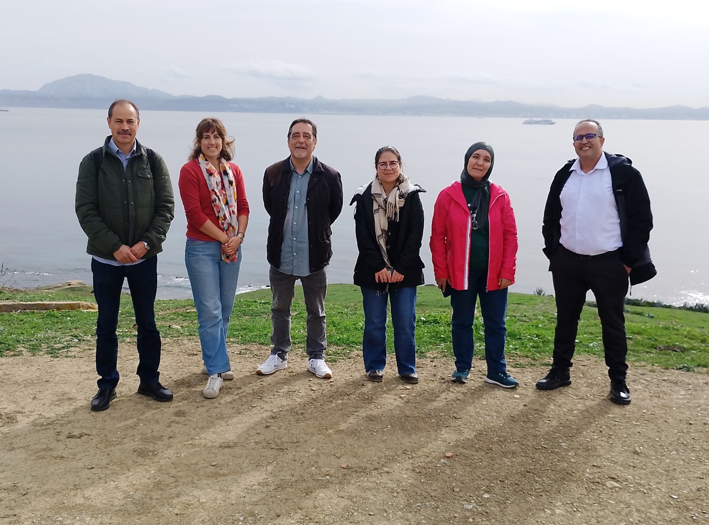 Moroccan Delegation and IUCN Med team posing in front of the sea at the Cima Migres Observatory