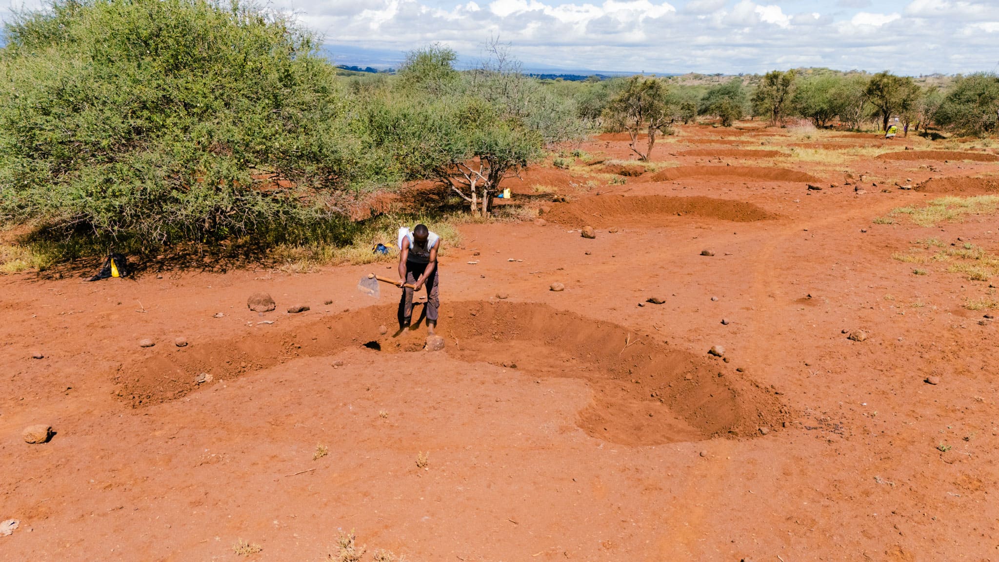 farmer in digging bunds in his farm